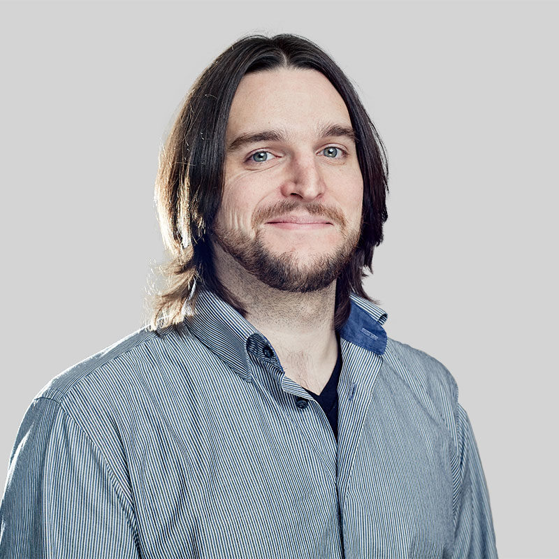Smiling man with long hair and beard.